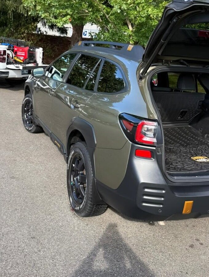 Green Subaru Outback after a wash with the hatch open