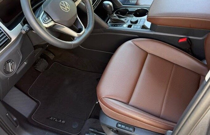 Brown leather passenger seat and clean floor mat
